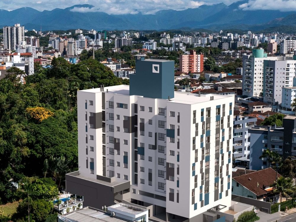 Detalhe do edifício DOT cercado por áreas verdes e imóveis modernos no bairro Saguaçu em Joinville