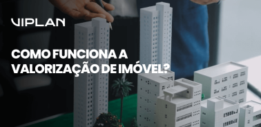 Maquete de prédios sendo analisada por profissionais, ilustrando de forma visual como funciona a valorização de imóvel e os fatores que influenciam esse processo.